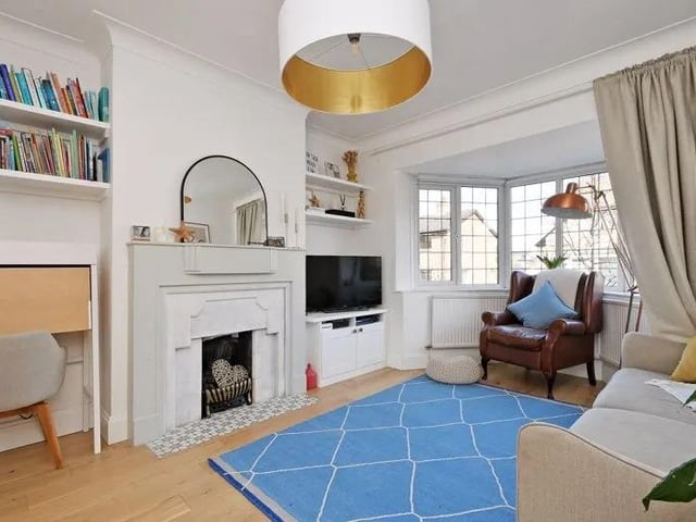 The living room seems an extension to the open plan space to the rear when the doors between them are opened fully.