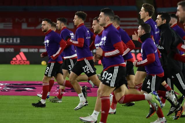 Sheffield United players warm up ahead of the Premier League match against Manchester United at Bramall Lane (Photo by RUI VIEIRA/POOL/AFP via Getty Images)
