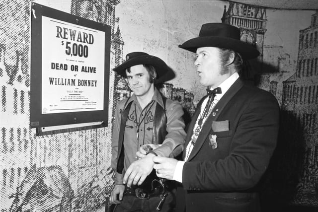 Dressed as cowboys and Western characters Dick Gilmour (as Marshall Dillon) 'arrests' Jim Webb (as Billy the Kid) ina Paisley Road West club, Glasgow, November 1980.