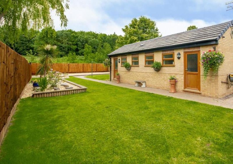 A big surprise in the back garden is this impressive outbuilding. Perhaps it could be converted into kennels?