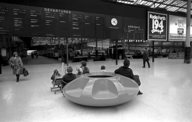 Rail passengers sitting on the circular plastic seating on the concourse of Waverley Station, newly modernised in November 1984.
