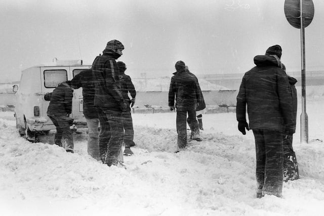 It's a tough task to get this van out of the snow in 1979.