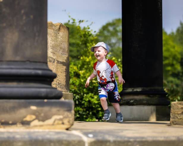 A young visitor explores the Ionic Temple in the gardens at Wentworth Woodhouse