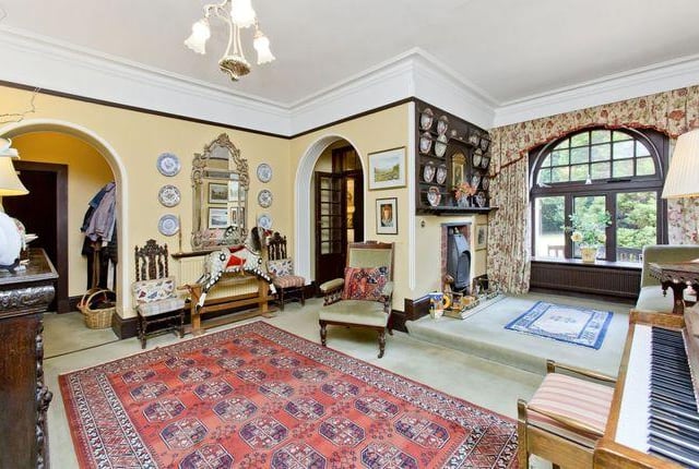Sliding doors link the drawing room to the double-aspect sunroom with a vaulted ceiling