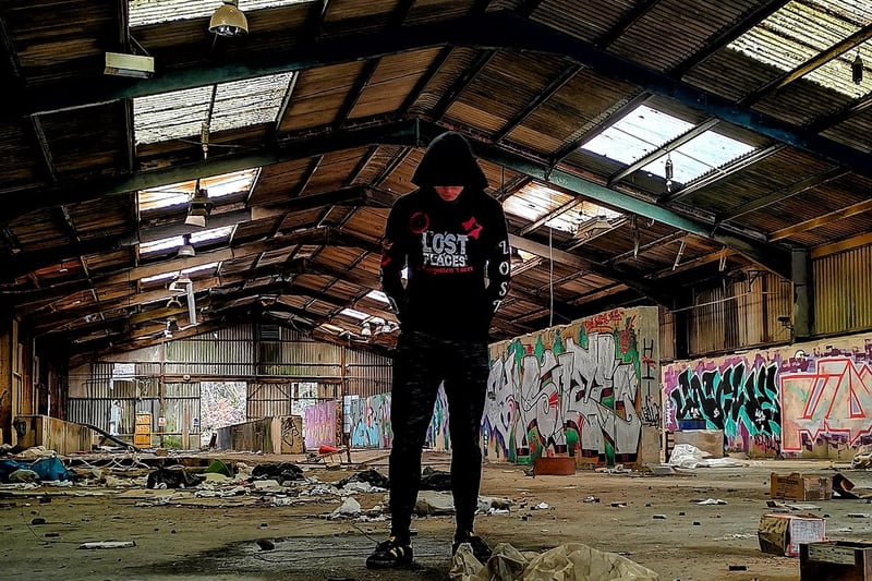 An urban explorer inside the heavily graffitied main shed.
