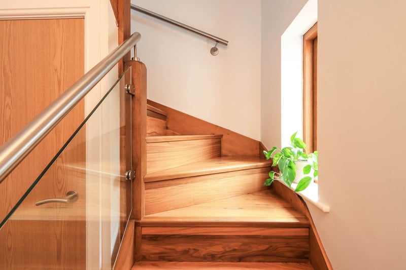 "A feature staircase with glass balustrade provides access to the open plan living room/kitchen," says the brochure.