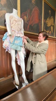 Student Danni Ward with her Georgian-inspired fashion design, on show in the Chapel at Wentworth Woodhouse