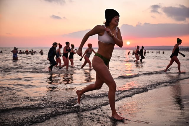 Several hundred swimmers took a sunrise dip in the North Sea at Portobello Beach, for the International Women's Day Swimrise. (Photo by Jeff J Mitchell/Getty Images)