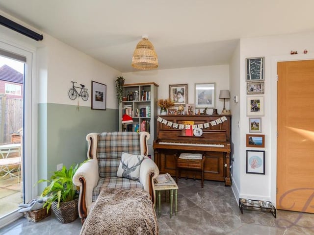 By the bi-folding doors, looking out on to the garden, put your feet up and relax in this quiet corner of the living area.
