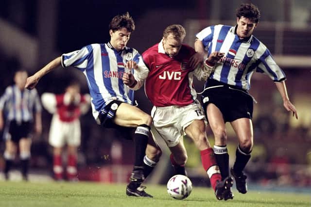 Petter Rudi (left) and Danny Sonner pay close attention to Arsenal legend Dennis Bergkamp at Highbury.