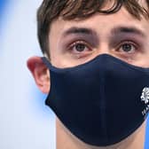 Tears well in the eyes of gold medallists Britain's Thomas Daley and Britain's Matty Lee (unseen) as they wait to receive their medals after wining the men's synchronised 10m platform diving final event during the Tokyo 2020 Olympic Games at the Tokyo Aquatics Centre in Tokyo on July 26, 2021. (Photo by Oli SCARFF / AFP) (Photo by OLI SCARFF/AFP via Getty Images)