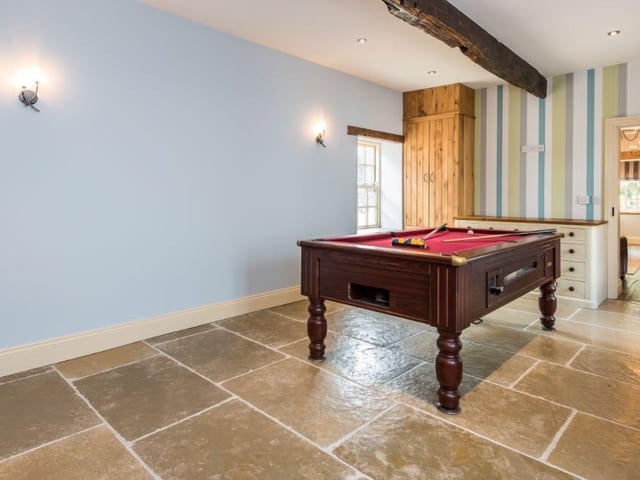 While this room is currently being used as a games room, the space could be converted into another sitting room or additional home office.