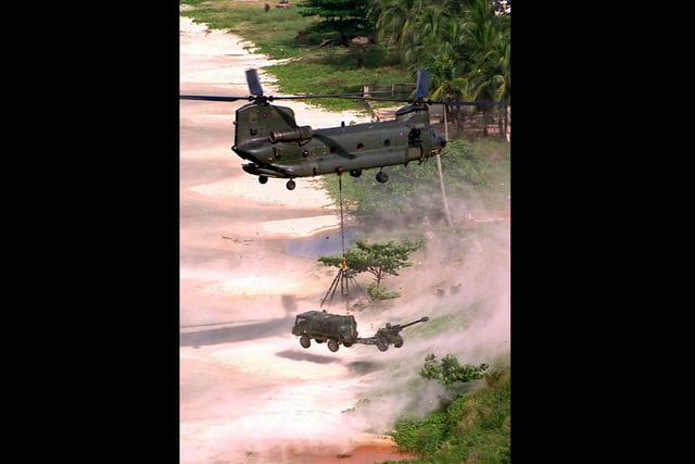 A Chinook CH-47 from RAF Odiham 18 Squadron prepares to lower o 105 gun and Pinzagower Vehicle at Aberdeen beach in the north west of the Sierra Leone capital of Freetown Monday November 13, 2000.They were some of 600 Royal Marines from Britain's Amphibious Ready Group, supported by artillery and helicopters, who came ashore as part of Operation Silkman, which aims to demonstrate Britain's ability to deploy troops rapidly to the troubled West African country.  The landing came only days after the ceasefire signed between the government of Sierra Leone and the rebel Revolutionary United Front (RUF).  PA photo: Ministry of Defence / Handout / Leading Airman  (photographer) Darren Casey