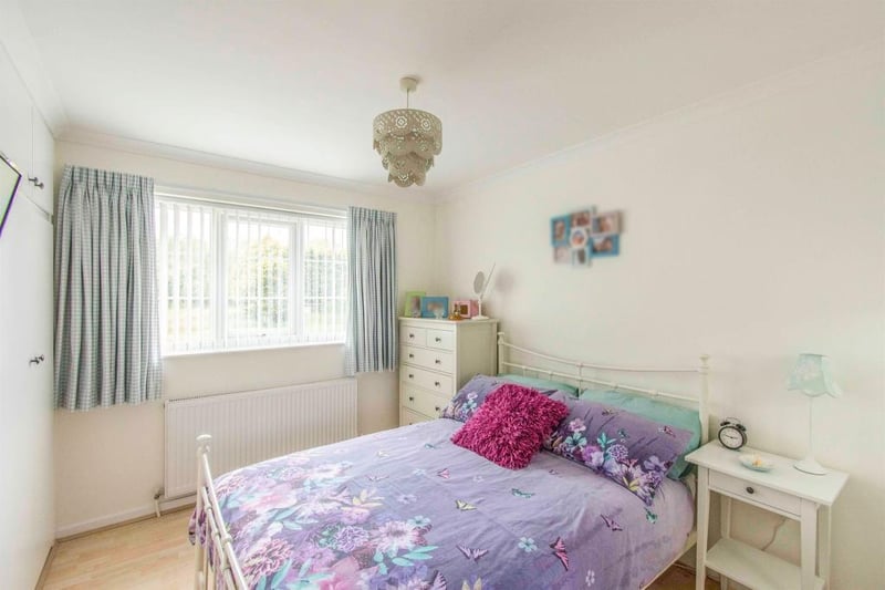 Bedroom 3 - a double room with a front facing double glazed window, a central heating radiator, fitted wardrobes and dressing table, coving to the ceiling and laminate flooring.