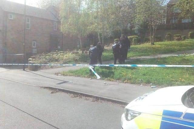 Police officers searching land after one of two shootings on Grimesthorpe Road, Burngreave, Sheffield