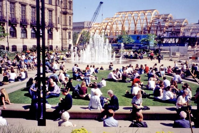 Sunbathers were able to look on from the Peace Gardens as the work continued.