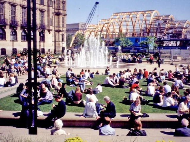 Sunbathers were able to look on from the Peace Gardens as the work continued.