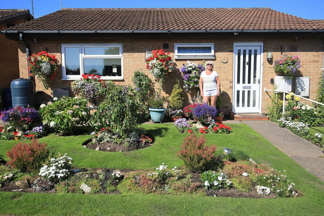 In August, Peter Evans, of Somersby Court, Mansfield, wanted to praise his neighbours for making their gardens look so wonderful and a reason to smile in a tough year. Pictured is Eireen Brooks with her garden.
