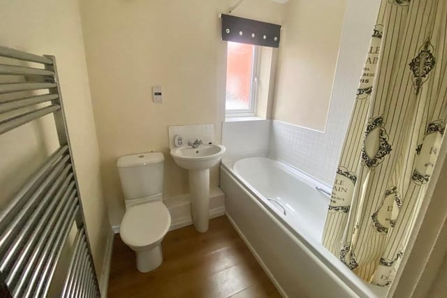 The bathroom, which can be accessed from both bedrooms via an inner hallway, is stylish, as you can see. A three-piece suite comprises a bath, wash hand basin and low-level WC.