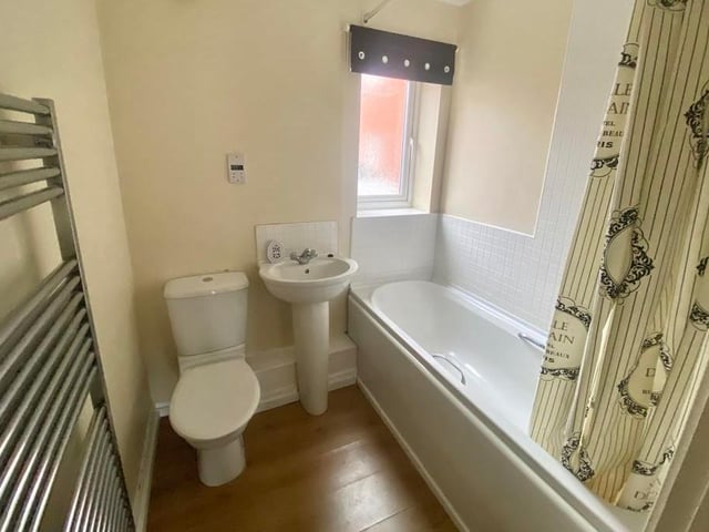 The bathroom, which can be accessed from both bedrooms via an inner hallway, is stylish, as you can see. A three-piece suite comprises a bath, wash hand basin and low-level WC.