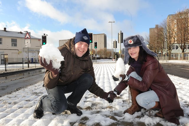 Matt Loraine and Yana Parkhomenko enjoy the snow in Winston Churchill Avenue.