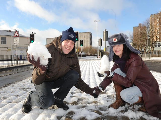 Matt Loraine and Yana Parkhomenko enjoy the snow in Winston Churchill Avenue.