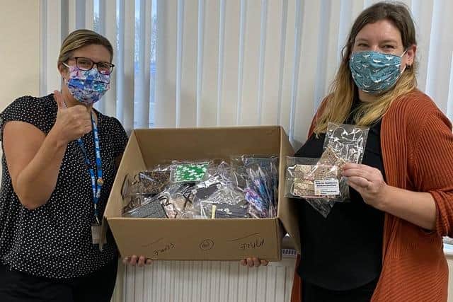 Wendy Cutts, service manager for outpatient and support services, receiving face masks from Sally Atkinson, patient access service manager at The Rotherham NHS Foundation Trust. Copyright -The Rotherham NHS Foundation Trust