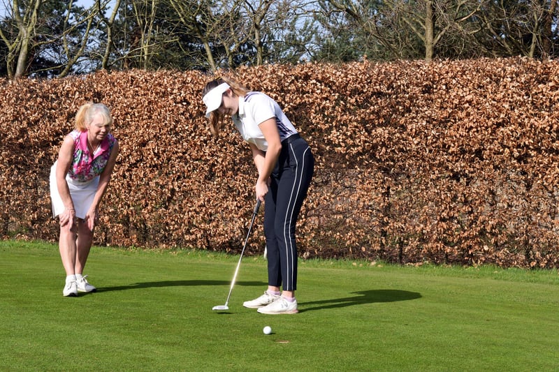 Lady captain Kay Vickers and Ellie Parker practice on one of the club's two putting greens.