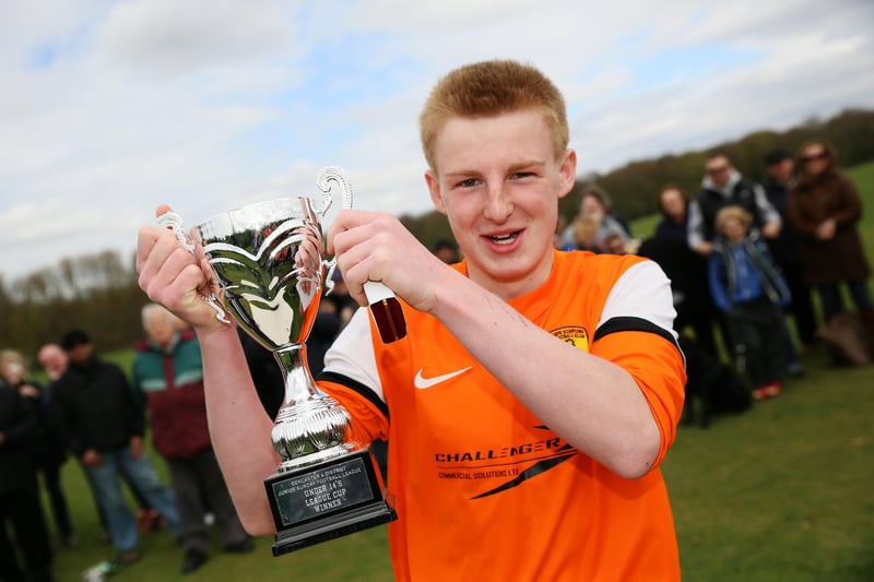 U14s captain James Hurdley holds aloft the League Cup after victory over Fishlake Falcons at Cantley Park.