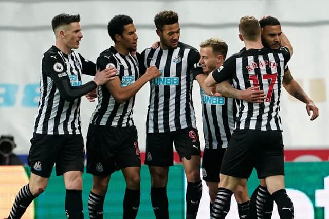 Newcastle United's English defender Jamaal Lascelles (R) celebrates with teammates after scoring the opening goal of the English Premier League football match between Newcastle United and Wolverhampton Wanderers at St James' Park in Newcastle-upon-Tyne, north east England on February 27, 2021
