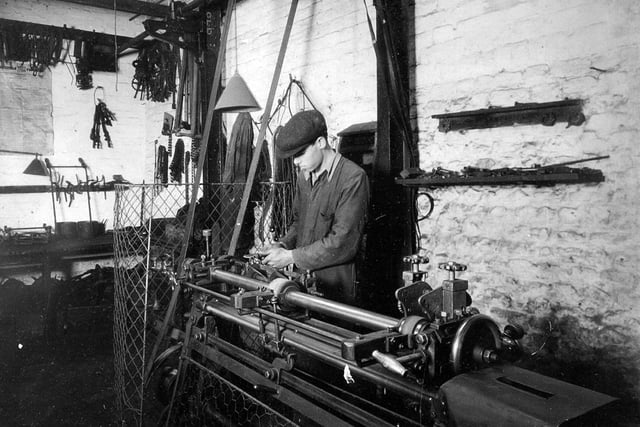 An employee working on a lathe at 'Streets' in East Street at Havant. Undated