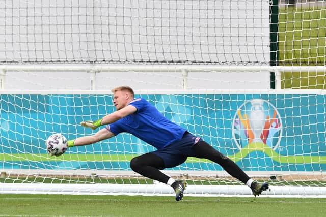 England's goalkeeper Aaron Ramsdale stops a ball during his team's training session on the eve of the UEFA EURO 2020 Group D football match between England and Scotland. (Photo by JUSTIN TALLIS / AFP)