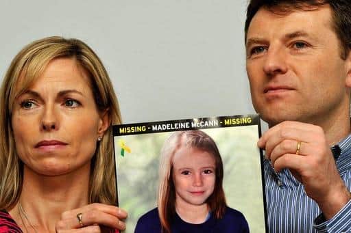 Madeleine McCann's parents hold a computer generated age progression photo of what the missing girl might look like now (Pic: PA)
