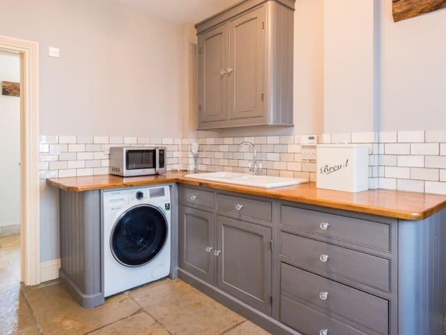 The utility room provides some additional storage space to avoid clutter, and is adjacent to the downstairs bathroom, which comprises a toilet and stand-in shower.