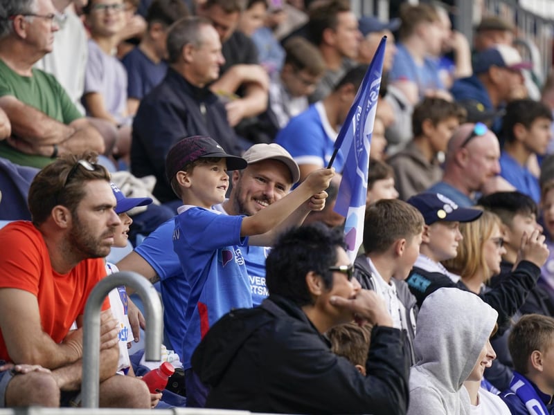 7 October 2023: A young Pompey fan waves the blue flag as the Blues won 2-0