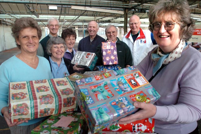 Right, area coordinator Madeleine McClintock with volunteers from Operation Christmas Child with some of the shoe boxes for Christmas.  Pictured at Nursery Works, Little London Road in 2004