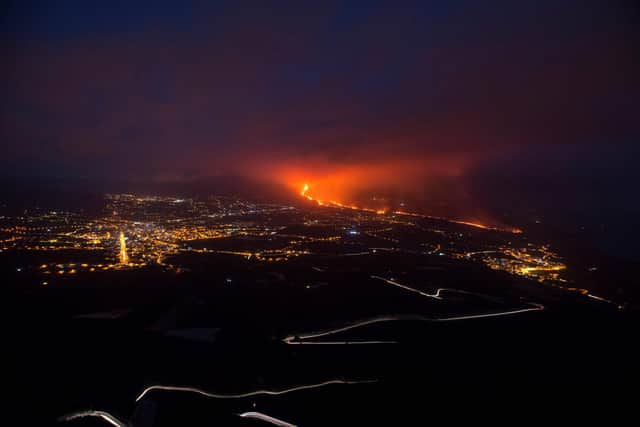 The Cumbre Vieja volcano, pictured from Tijarafe, spews lava, ash and smoke, on the Canary Island of La Palma, at night on October 10, 2021.(Photo by JORGE GUERRERO / AFP) (Photo by JORGE GUERRERO/AFP via Getty Images)
