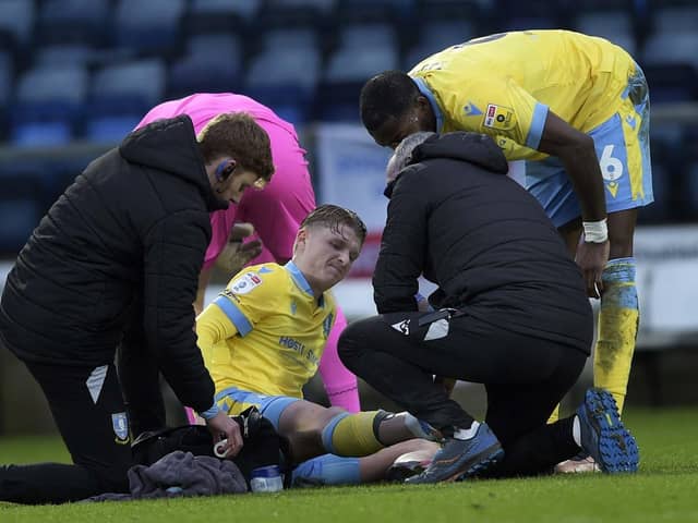 Sheffield Wednesday's George Byers getting treatment while injured away at Wycombe Wanderers earlier in the season.