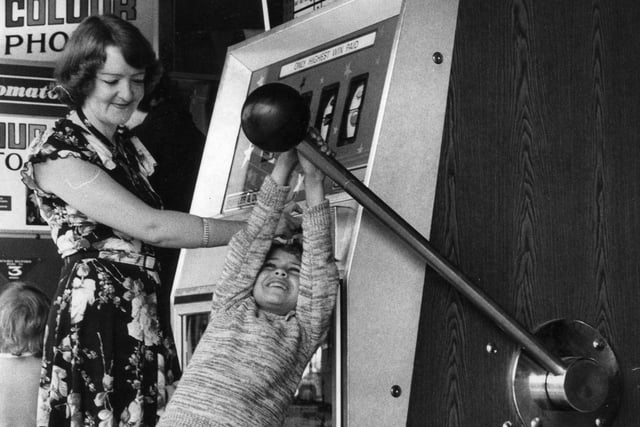 Lorraine Cardno, 7 having a go on the giant one armed bandit in South Shields fairground in 1977 with mum Sandra watching.