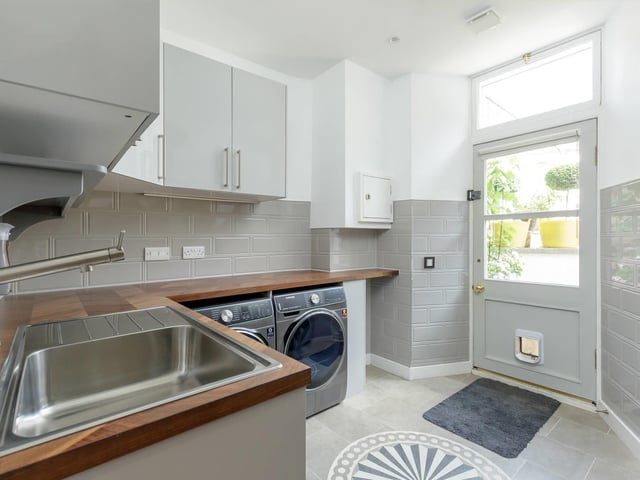 The utility room has a laundry chute, which is connected to the top floor. It makes doing the washing much easier and more convenient.