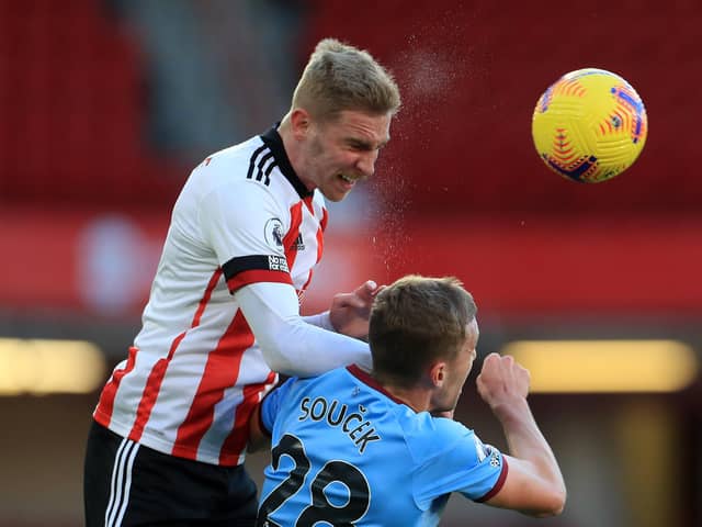 Sheffield United's English-born Scottish striker Oli McBurnie (L) and West Ham United's Czech midfielder Tomas Soucek (R) go up for a header during the English Premier League football match between Sheffield United and West Ham United at Bramall Lane in Sheffield, northern England on November 22, 2020. (Photo by MIKE EGERTON / POOL / AFP) / RESTRICTED TO EDITORIAL USE. No use with unauthorized audio, video, data, fixture lists, club/league logos or 'live' services. Online in-match use limited to 120 images. An additional 40 images may be used in extra time. No video emulation. Social media in-match use limited to 120 images. An additional 40 images may be used in extra time. No use in betting publications, games or single club/league/player publications. /  (Photo by MIKE EGERTON/POOL/AFP via Getty Images)