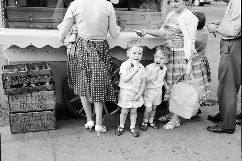 Heatwave in Edinburgh -  Youngsters Gordon Macpherson and Neill MacPherson eating ice cream at an ice cream van in Princes Street,  August 1961.