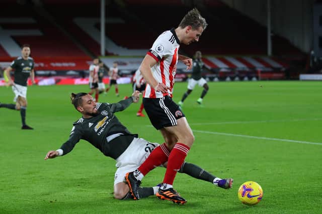 Sander Berge of Sheffield United tussles with Alex Telles of Manchester United: Simon Bellis/Sportimage