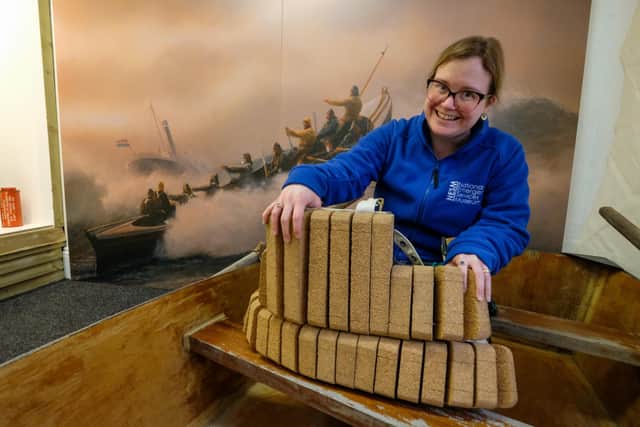 Rosie Norrell puts the finishing touches to a display at coastguard history exhibition Guarding the Coast at the National Emergency Services Museum, Sheffield