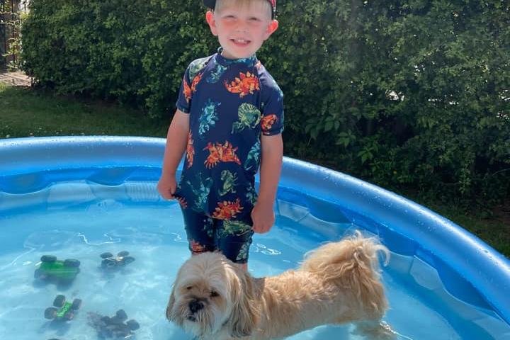 Zak and Freddie keeping cool in a paddling pool.
