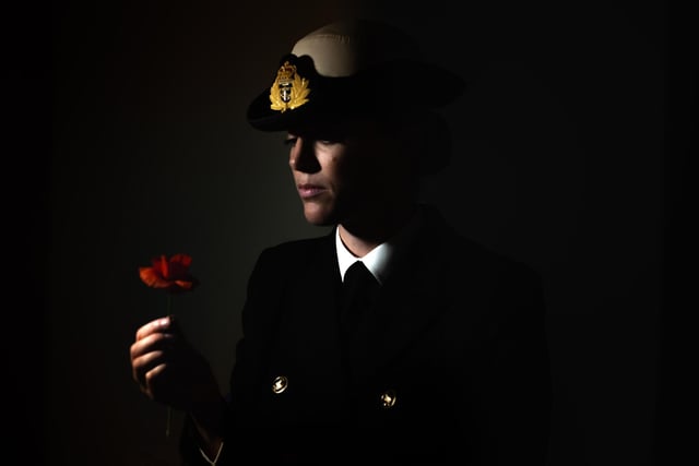 Lt Cdr holds a symbolic poppy as part of a portrait photograph taken for Remebrance Day, Nov 21. 