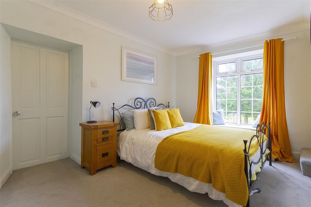 A side facing double bedroom having a built-in double wardrobe and a door to an en suite bathroom. Plus a further door gives access to a staircase which rises to the attic room.