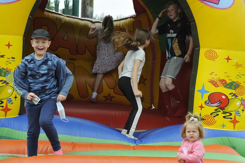 Youngsters enjoy the bouncy castle while parents marvel at the brand new California Community Hub