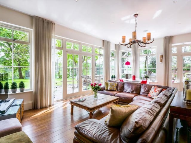 Lighter and more airy than the other sitting room, there's also a door to the seating area outside.