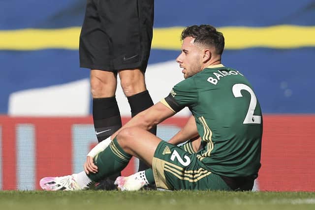 Sheffield United's English defender George Baldock sits on the pitch after taking a knock in a challenge during the English Premier League football match between Leeds United and Sheffield United at Elland Road: LINDSEY PARNABY/POOL/AFP via Getty Images
